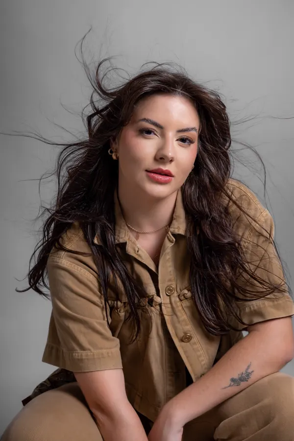 Retrato com camisa caramelo e cabelo em movimento